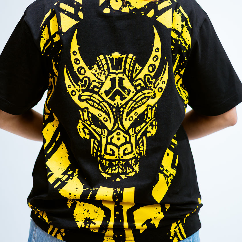 Black Defqon.1 t-shirt with yellow tribal design on a plain background